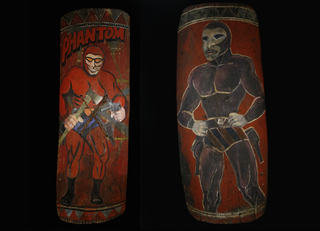 Illustration for article titled Why Does This Comic Book Hero Appear On So Many New Guinea War Shields?